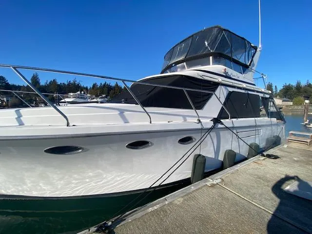 Slide: The Image of 1989 Ocean Alexander 42 yacht docked under clear blue sky. - 3