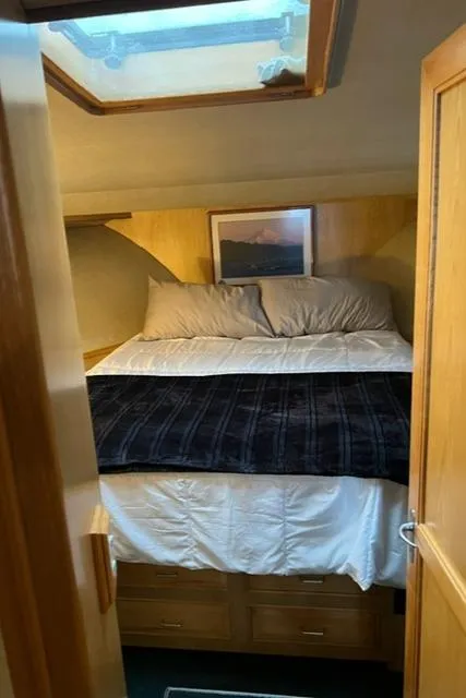 Slide: The Image of Cozy bedroom in 1989 Ocean Alexander 42 yacht with skylight and wooden accents. - 33