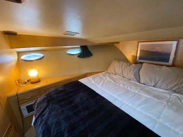 Slide: The Image of Cozy cabin interior of 1989 Ocean Alexander 42 yacht with bed and porthole windows. - 34