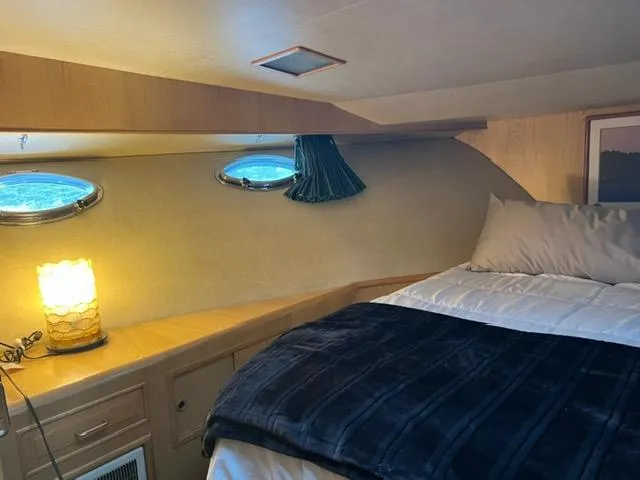 Slide: The Image of Cozy cabin interior of 1989 Ocean Alexander 42 yacht with bed and ambient lighting. - 35