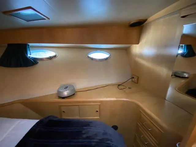 Slide: The Image of Interior cabin of 1989 Ocean Alexander 42 yacht with portholes and wooden cabinetry. - 36