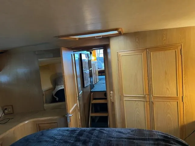 Slide: The Image of Interior of 1989 Ocean Alexander 42 yacht with wooden cabinetry and cozy sleeping area. - 38