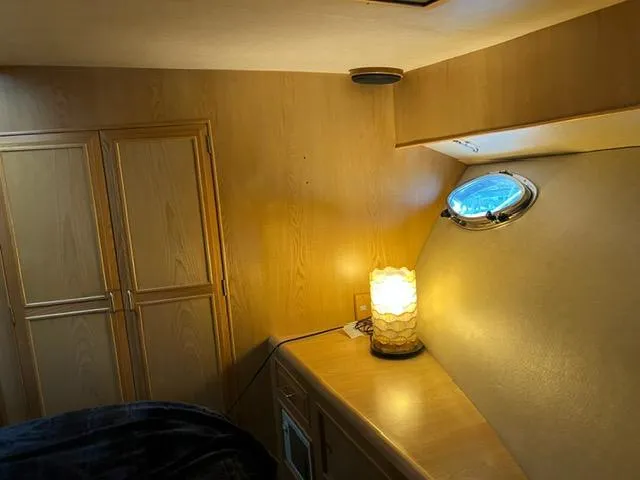Slide: The Image of Interior of 1989 Ocean Alexander 42 yacht with wooden cabinets and a porthole window. - 39