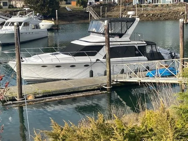 Slide: The Image of 1989 Ocean Alexander 42 yacht docked in a serene marina setting. - 4