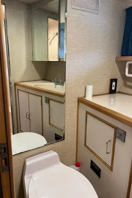 Slide: The Image of Bathroom interior of 1989 Ocean Alexander 42 yacht, featuring sink, mirror, and toilet. - 41