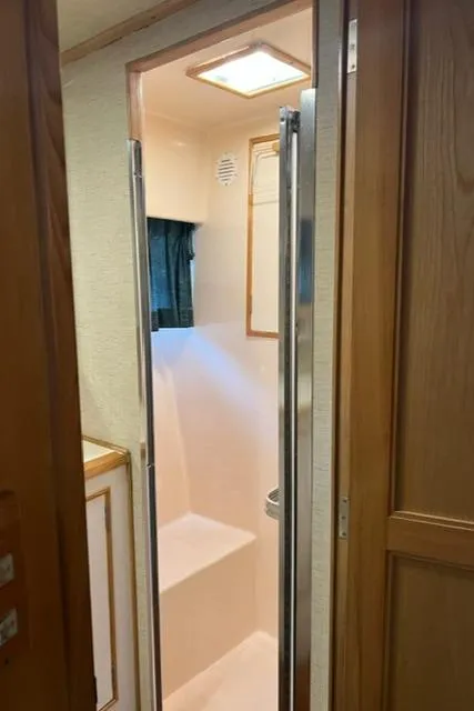 Slide: The Image of Shower area in 1989 Ocean Alexander 42 yacht, featuring compact design and natural lighting. - 42