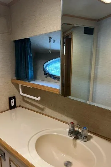 Slide: The Image of Bathroom interior of 1989 Ocean Alexander 42 yacht, featuring sink and mirror. - 43