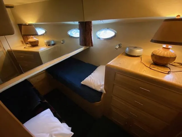 Slide: The Image of Cozy cabin interior of 1989 Ocean Alexander 42 yacht with wooden furnishings and porthole windows. - 44