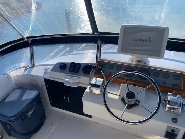 Slide: The Image of Helm of 1989 Ocean Alexander 42 with Garmin navigation system and steering wheel. - 49