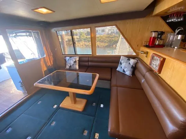 Slide: The Image of Interior of 1989 Ocean Alexander 42 yacht with brown seating and glass table. - 6