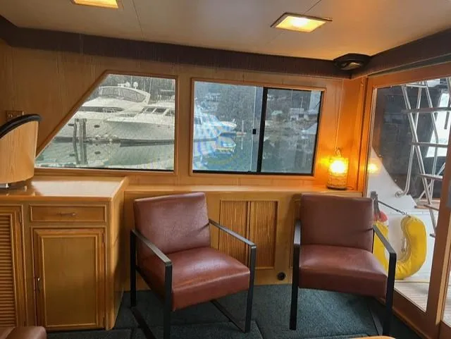 Slide: The Image of Interior of 1989 Ocean Alexander 42 yacht with two chairs and a window view. - 8