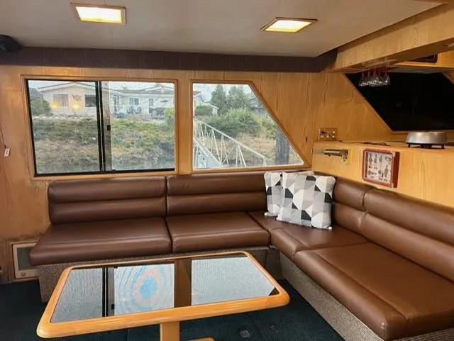 Slide: The Image of Interior of 1989 Ocean Alexander 42 yacht with brown leather seating and a glass-top table. - 9