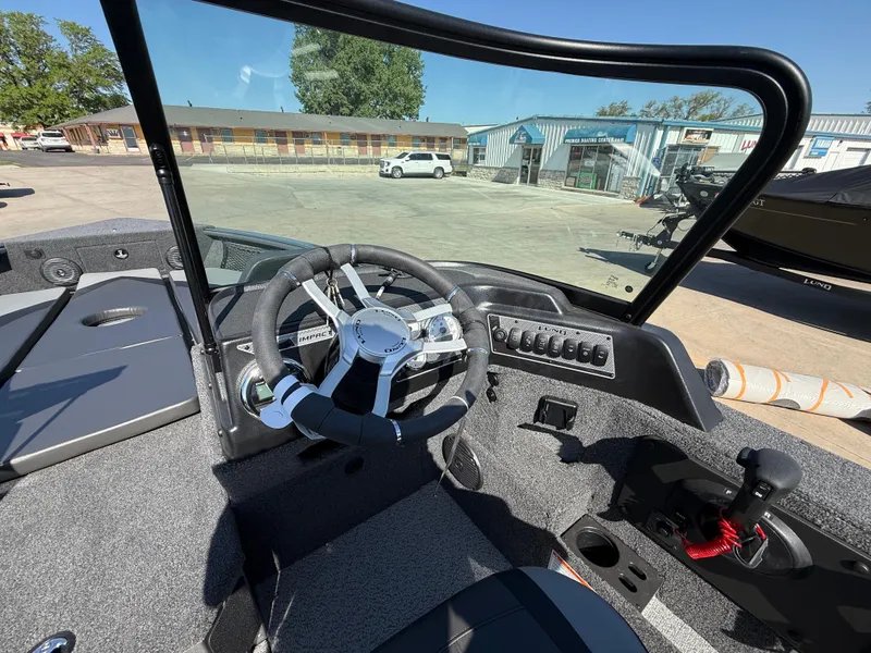 Slide: The Image of 2025 Lund 2075 IMPACT XS boat cockpit with steering wheel and control panel. - 8