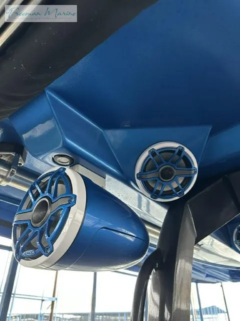 Slide: The Image of 2023 Fountain 43 NX boat speakers, blue and white design, mounted under canopy. - 11