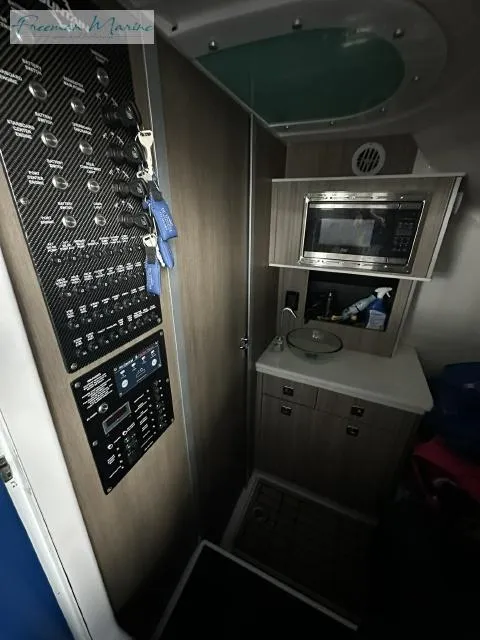 Slide: The Image of 2023 Fountain 43 NX interior with control panel and kitchenette. - 14