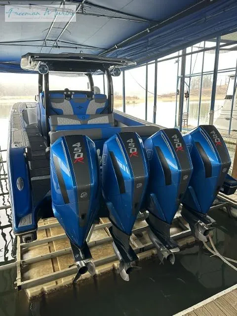 Slide: The Image of 2023 Fountain 43 NX boat with four powerful outboard engines in a marina. - 2