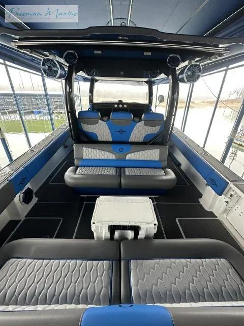 Slide: The Image of 2023 Fountain 43 NX boat interior with blue and gray seating, spacious layout, and modern design. - 5