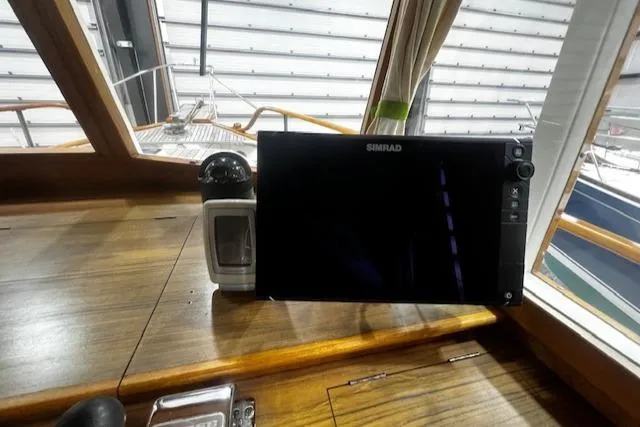 Slide: The Image of 1984 Grand Banks Trawler dashboard with navigation equipment and wooden finish. - 10