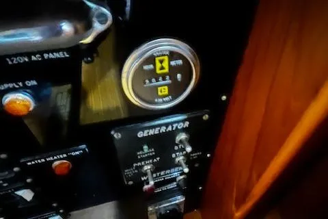 Slide: The Image of Control panel of a 1984 Grand Banks Trawler, featuring generator and electrical switches. - 20