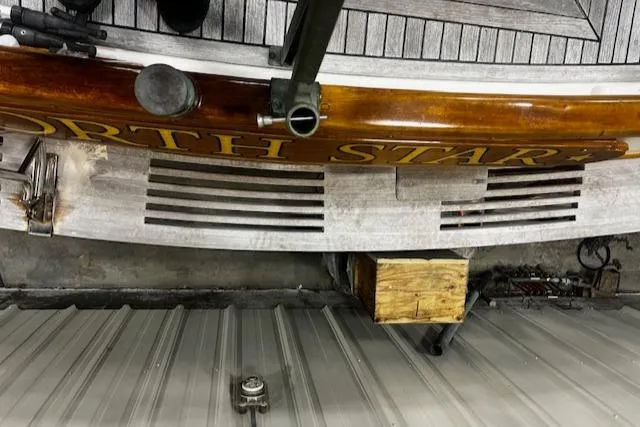 Slide: The Image of 1984 Grand Banks Trawler stern with "North Star" lettering, wooden deck, and metal fittings. - 25