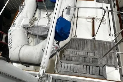 Slide: The Image of 1984 Grand Banks Trawler deck with inflatable dinghy and wooden steps. - 28