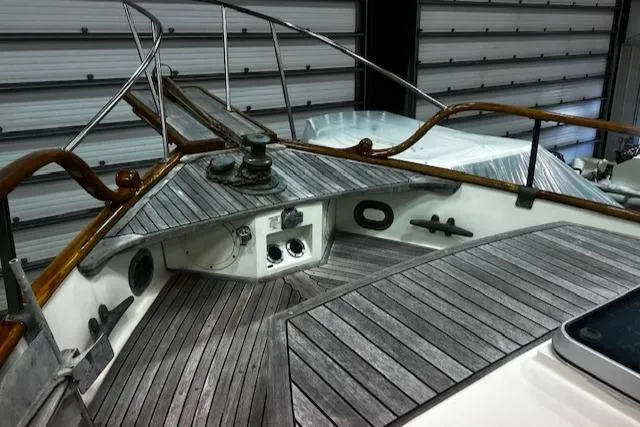 Slide: The Image of 1984 Grand Banks Trawler deck with wooden railings and nautical equipment. - 31