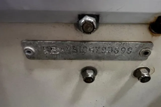 Slide: The Image of 1984 Grand Banks Trawler identification plate with serial number and bolts. - 33