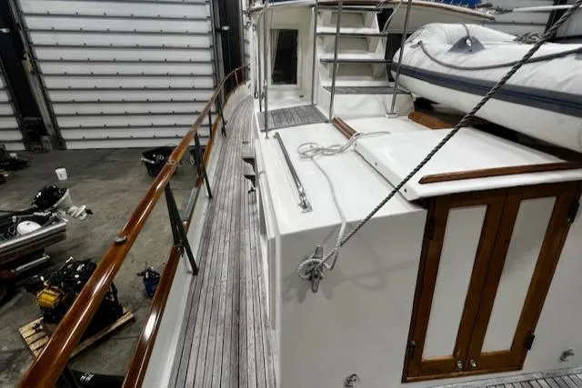Slide: The Image of 1984 Grand Banks Trawler in a workshop, showcasing deck and railing details. - 35