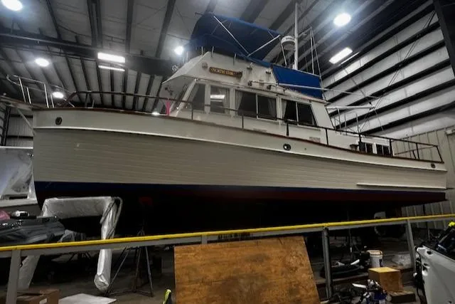 Slide: The Image of 1984 Grand Banks Trawler in a warehouse, showcasing classic design and sturdy construction. - 38