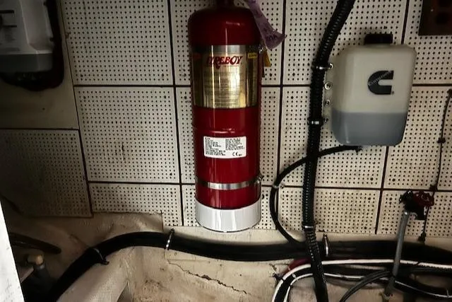 Slide: The Image of Engine room of 1984 Grand Banks Trawler with fire extinguisher and wiring. - 45