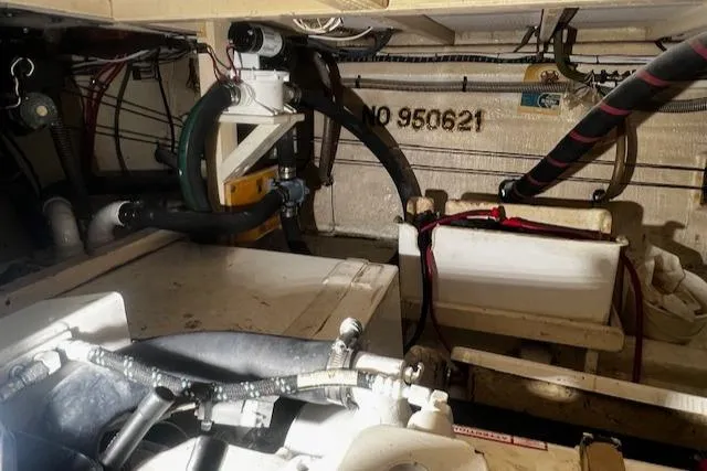 Slide: The Image of Engine room of 1984 Grand Banks Trawler with visible pipes and equipment. - 46