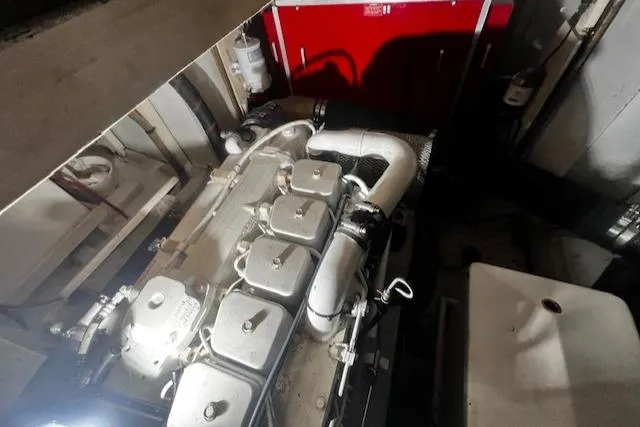 Slide: The Image of Engine room of a 1984 Grand Banks Trawler, showcasing mechanical components and piping. - 47