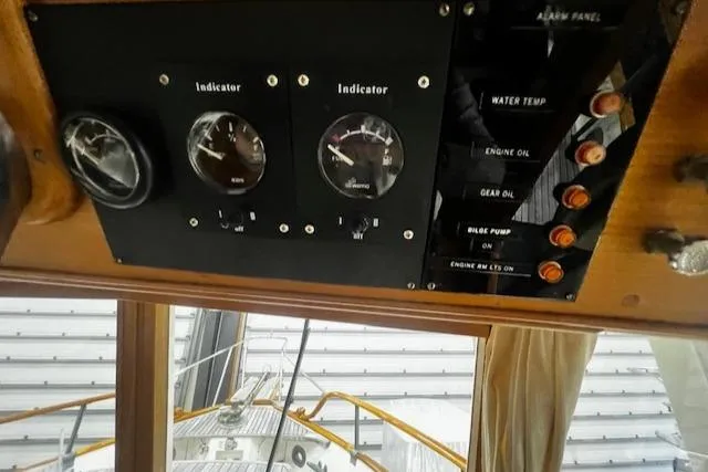 Slide: The Image of Control panel of a 1984 Grand Banks Trawler with gauges and indicators. - 9