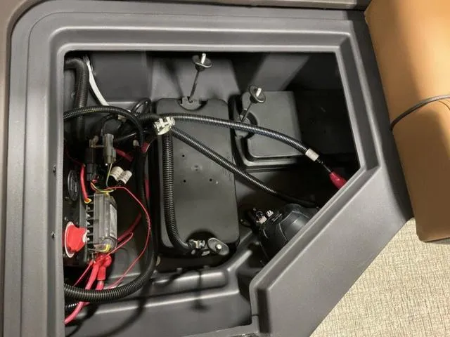 Slide: The Image of Battery compartment of 2025 Bennington M Quad Bench 26 MFB with wiring and components. - 12