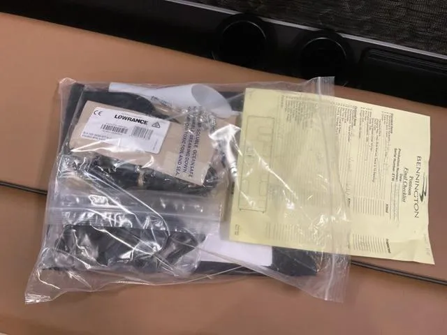 Slide: The Image of Bennington M Quad Bench 26 MFB 2025 accessories in plastic bag with Lowrance label. - 14