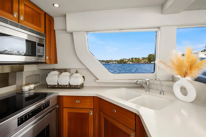 Slide: The Image of Luxurious kitchen interior of 2003 Pacific Mariner Pilothouse yacht with scenic window view. - 13