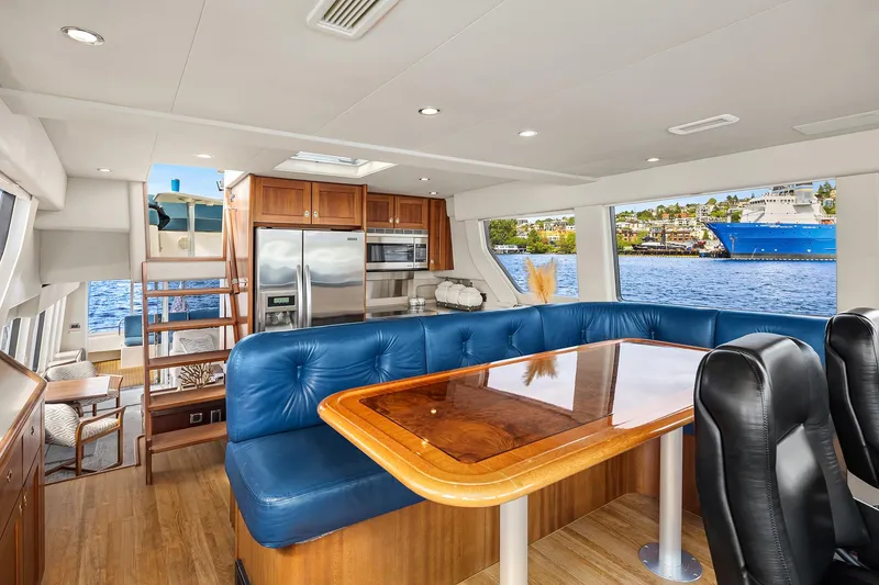 Slide: The Image of Luxurious 2003 Pacific Mariner Pilothouse interior with blue seating, wooden table, and modern kitchen. - 16