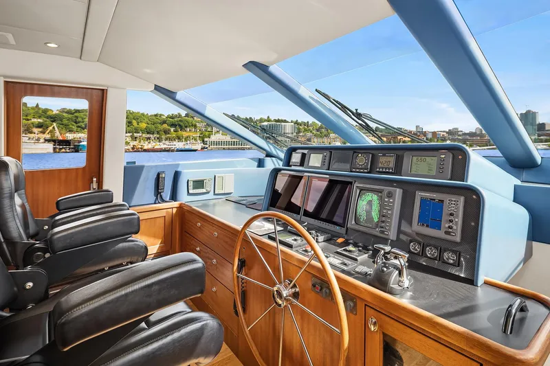 Slide: The Image of 2003 Pacific Mariner Pilothouse interior with navigation controls and leather seating. - 18