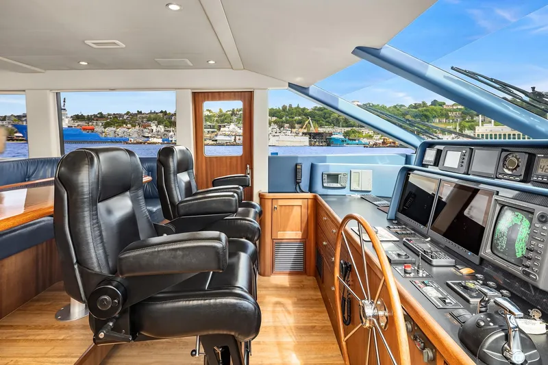 Slide: The Image of 2003 Pacific Mariner Pilothouse interior with leather chairs and advanced navigation equipment. - 19