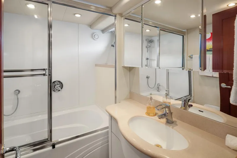 Slide: The Image of Luxurious bathroom in 2003 Pacific Mariner Pilothouse yacht with modern fixtures and mirrored cabinets. - 23