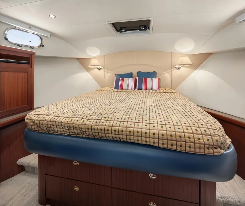 Slide: The Image of Luxurious 2003 Pacific Mariner Pilothouse bedroom with elegant bedding and wooden cabinetry. - 24