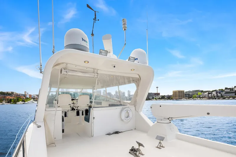 Slide: The Image of 2003 Pacific Mariner Pilothouse yacht on calm water with city skyline in background. - 27