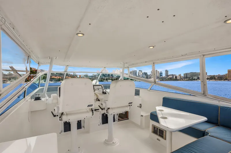 Slide: The Image of 2003 Pacific Mariner Pilothouse interior with seating, helm, and city skyline view. - 29