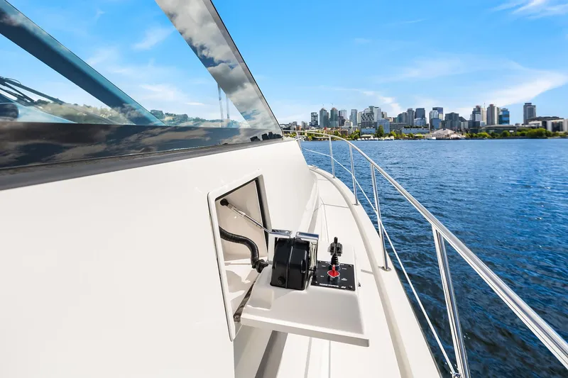 Slide: The Image of 2003 Pacific Mariner Pilothouse yacht with city skyline in the background. - 33