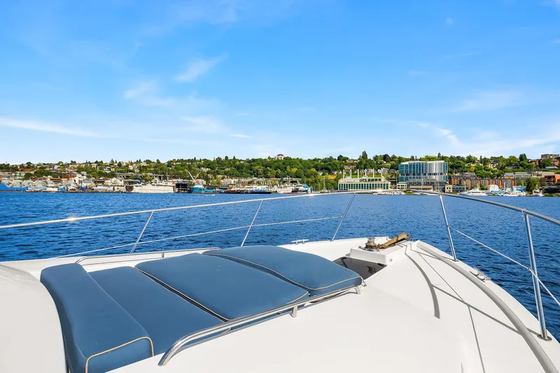 Slide: The Image of 2003 Pacific Mariner Pilothouse yacht cruising on a sunny day with scenic waterfront view. - 35