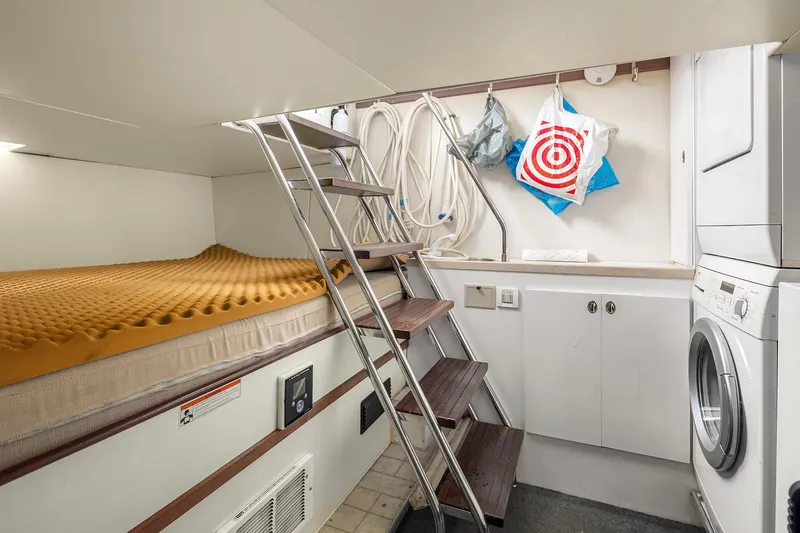 Slide: The Image of 2003 Pacific Mariner Pilothouse interior with bed, ladder, and laundry area. - 36