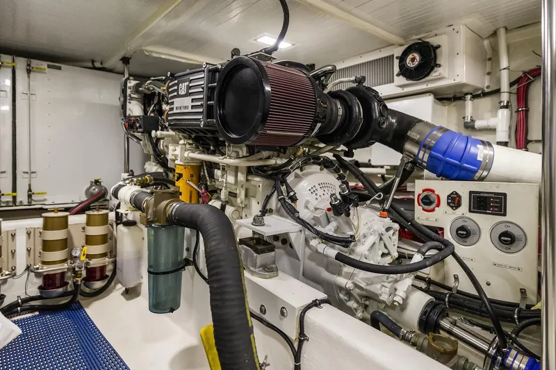 Slide: The Image of Engine room of a 2003 Pacific Mariner Pilothouse yacht, showcasing mechanical components and controls. - 38