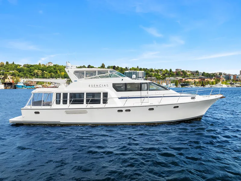 Slide: The Image of 2003 Pacific Mariner Pilothouse yacht on a sunny day, cruising on blue waters. - 44