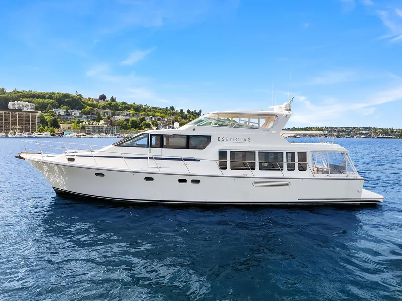 Slide: The Image of 2003 Pacific Mariner Pilothouse yacht on calm blue water under clear sky. - 47