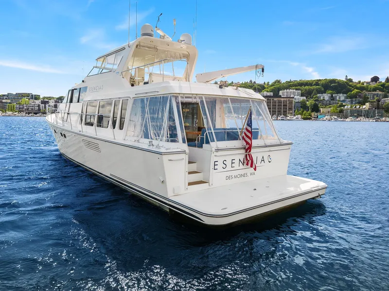 Slide: The Image of 2003 Pacific Mariner Pilothouse yacht on water, rear view with American flag. - 48